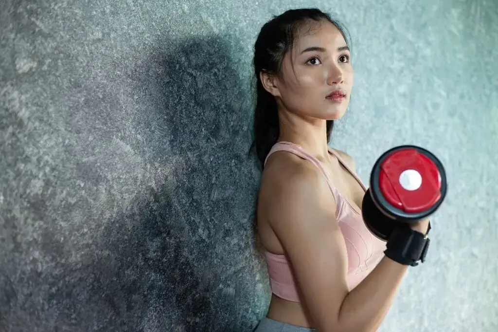 Woman doing solo personal training in Singapore at LTH Fitness during guided fitness workout session