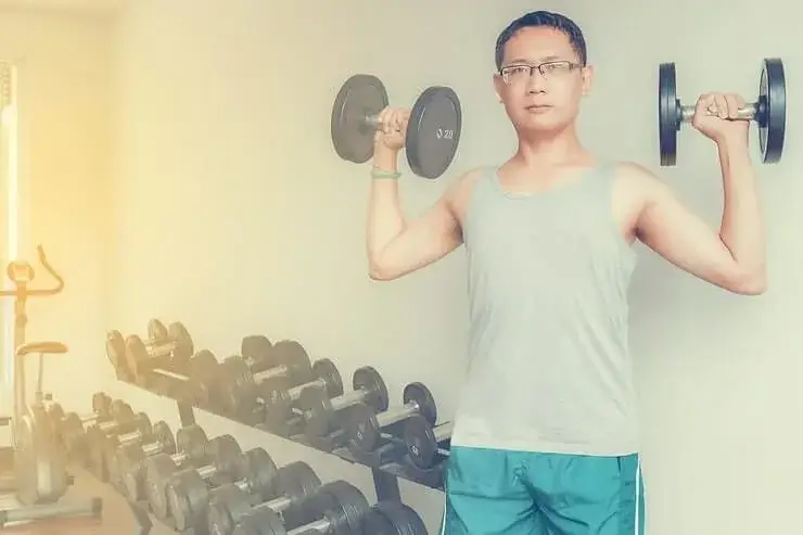Man in Singapore personal training workout performing guided strength exercises with a certified fitness coach.